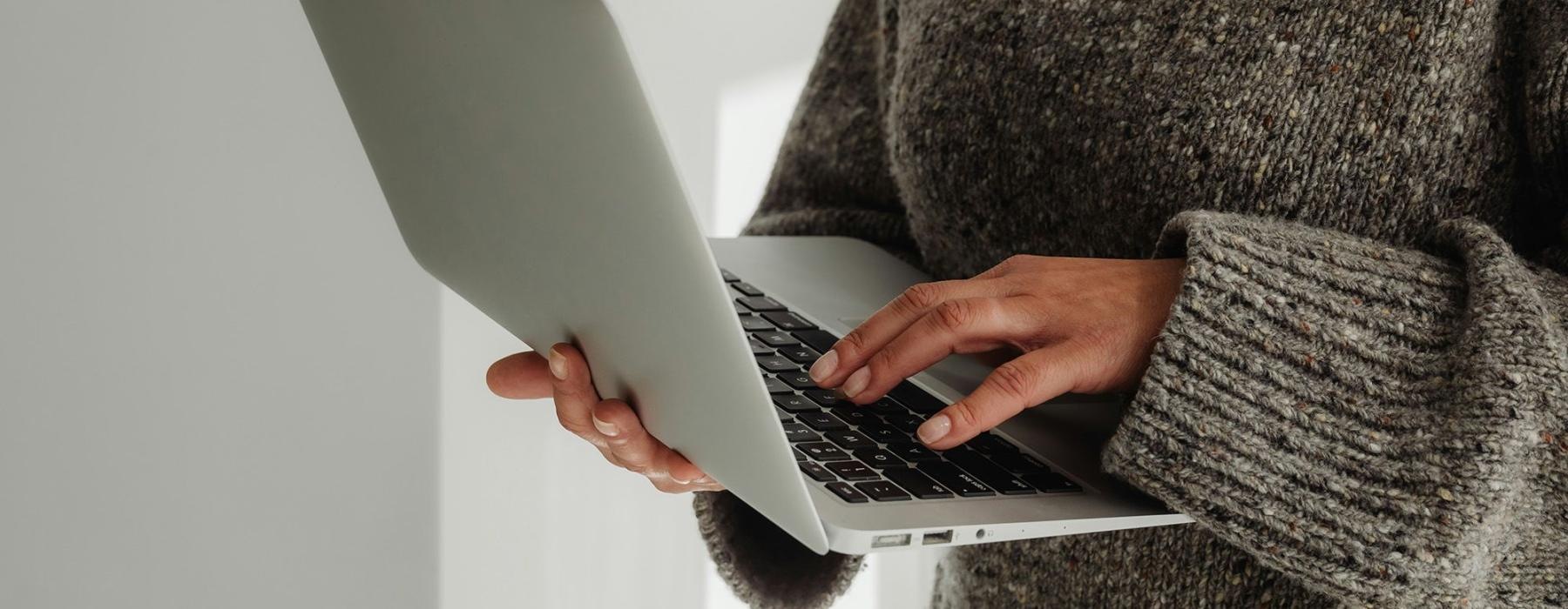 A person holding a laptop